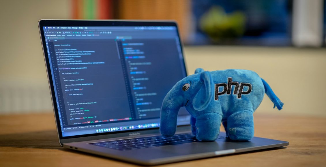 blue and white elephant plush toy on black laptop computer