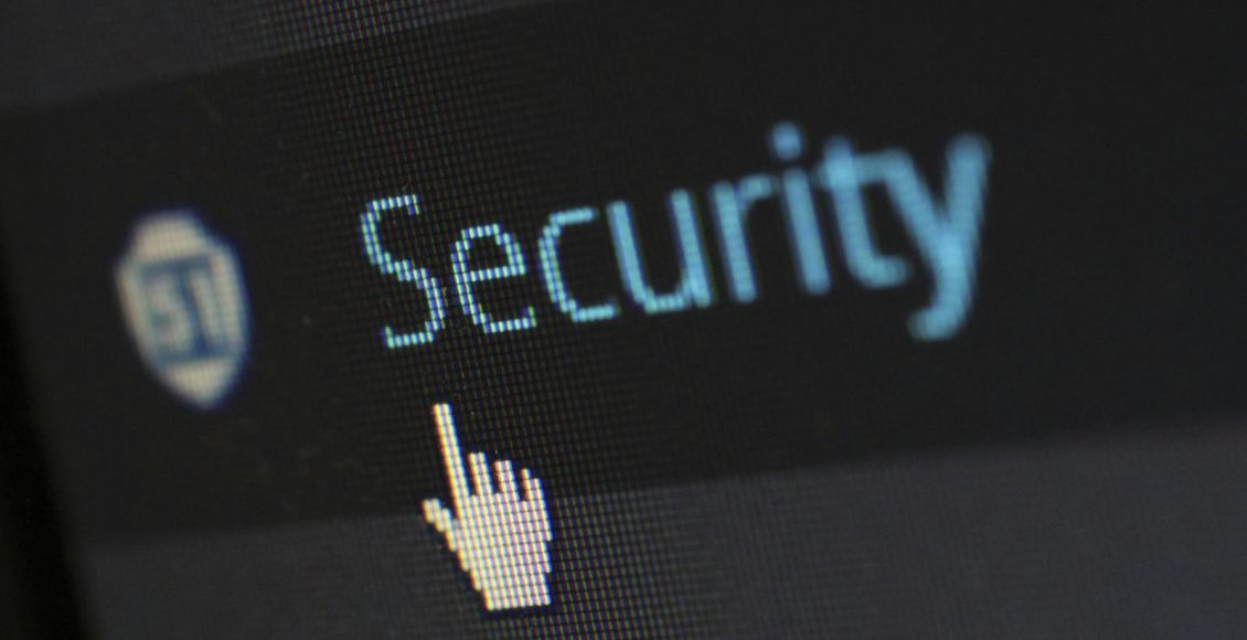 Close-up view of a mouse cursor over digital security text on display.