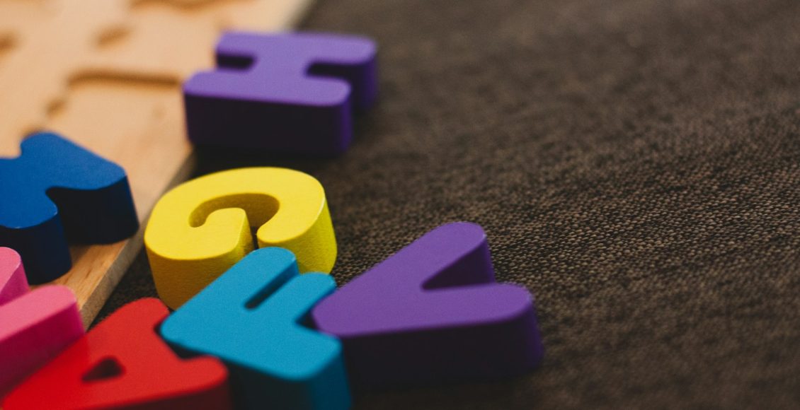 alphabet learning toy on gray apparel