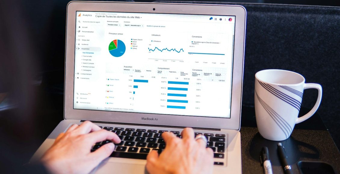 person using macbook pro on black table