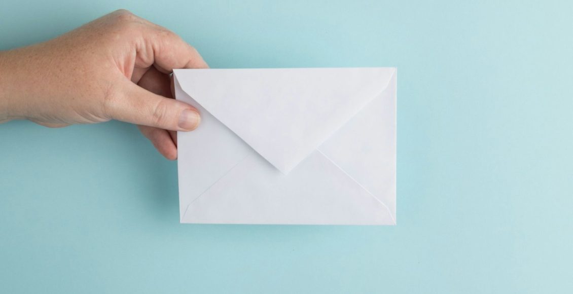 person showing white envelope