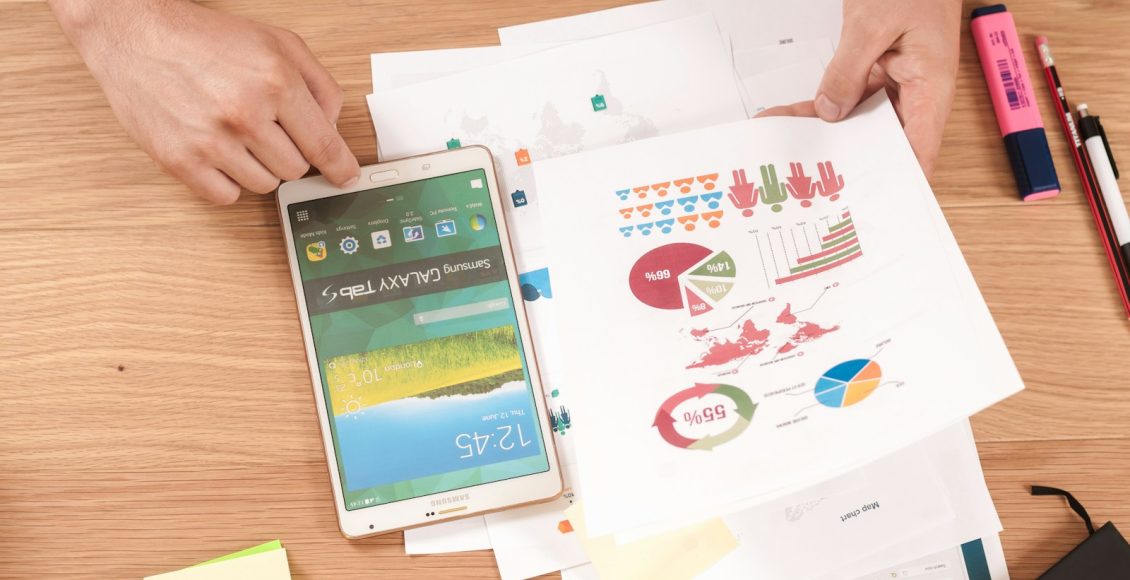 person holding white Samsung Galaxy Tab