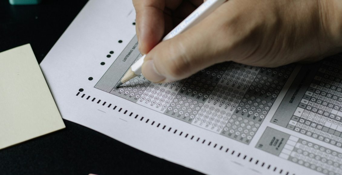 person writing on white paper