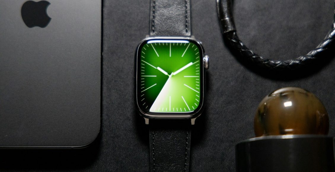 an apple watch sitting on top of a table next to a phone